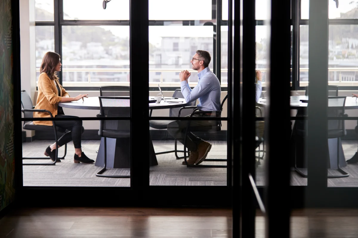Business Meeting at Round Table with Large Windows
