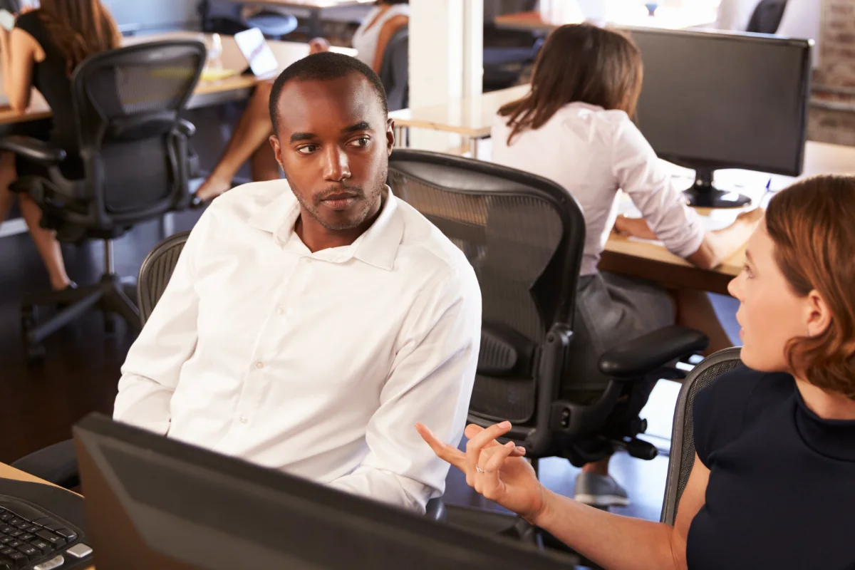 Businesspeople Working At Computers In Busy Modern Office