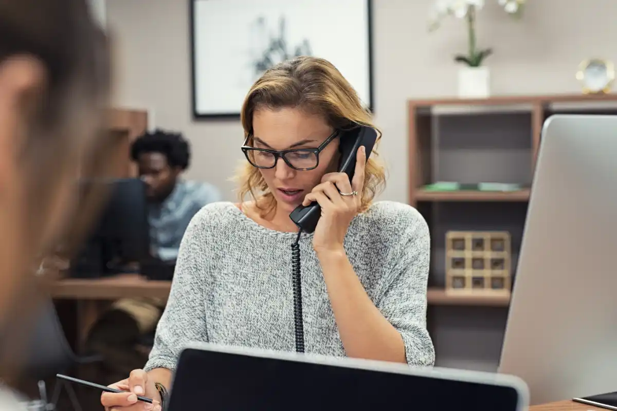 Businesswoman talking on phone at office